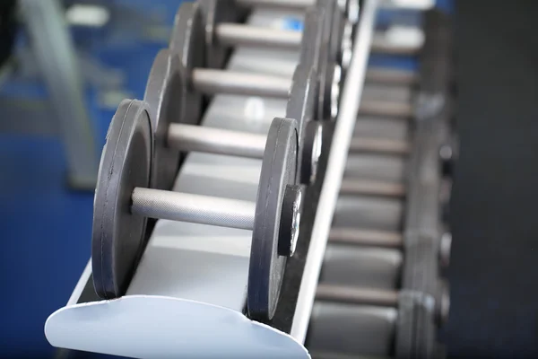 Lot of dumbbells in gym close-up — Stock Photo, Image