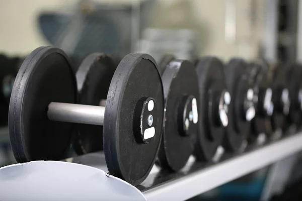 Lot of dumbbells in gym close-up — Stock Photo, Image