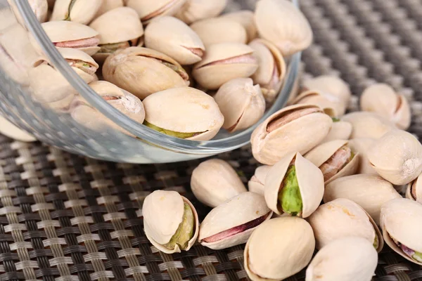 Pistachio nuts in glass bowl on table close up — Stock Photo, Image