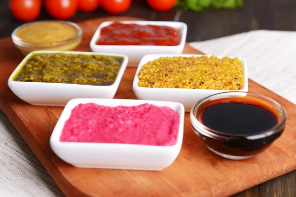 Various sauces on chopping board on table close-up — Stock Photo, Image