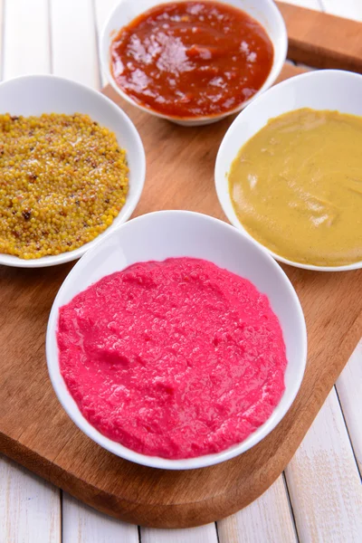 Various sauces on chopping board on table close-up — Stock Photo, Image