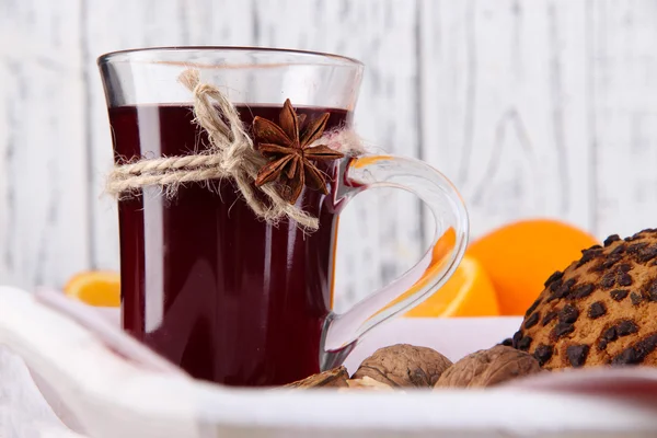 Mulled wine with oranges and cookies on table on wooden background — Stock Photo, Image