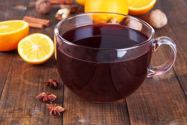 Mulled wine with orange and spices on wooden background — Stock Photo, Image