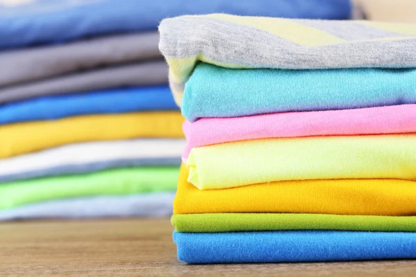 Stack of colorful clothes, on light background — ストック写真