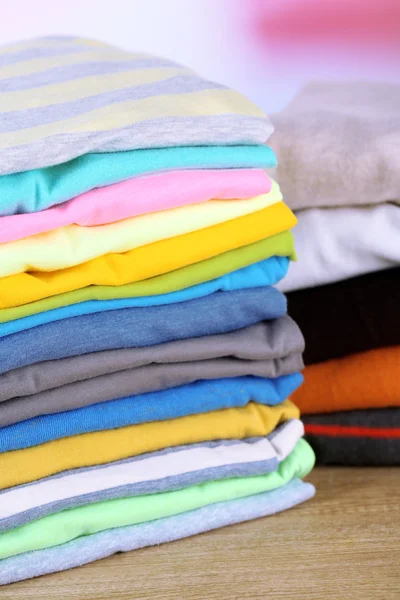 Stack of colorful clothes, on light background — ストック写真