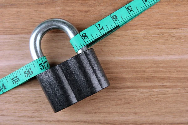 Conceptual photo of unlocking secret of weight loss. On color wooden background — Stock Photo, Image