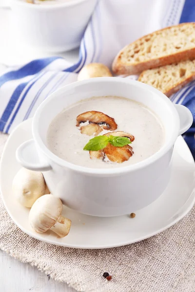 Mushroom soup in white pots, on napkin, on wooden background — Stock Photo, Image