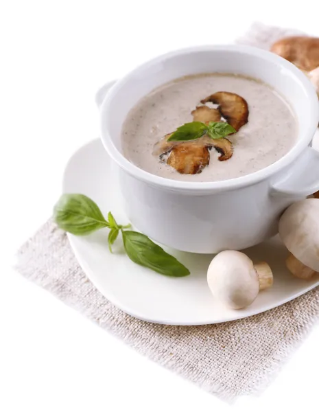 Mushroom soup in white bowl, on napkin, isolated on white — Stock Photo, Image