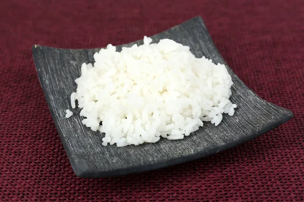 Cooked rice on red background — Stock Photo, Image