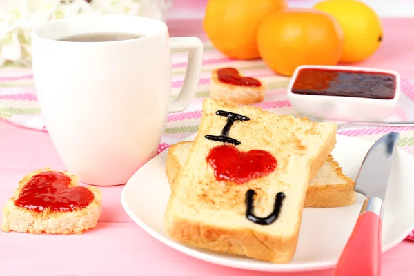 Delicioso brindis con mermelada y taza de té en primer plano de la mesa — Foto de Stock