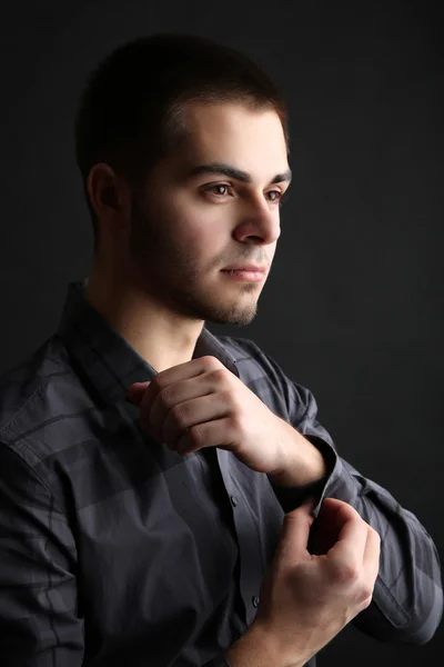 Handsome young man on dark background — Stock Photo, Image