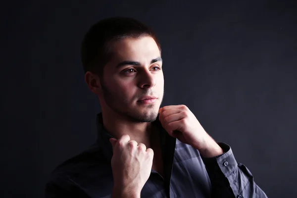 Handsome young man on dark background — Stock Photo, Image