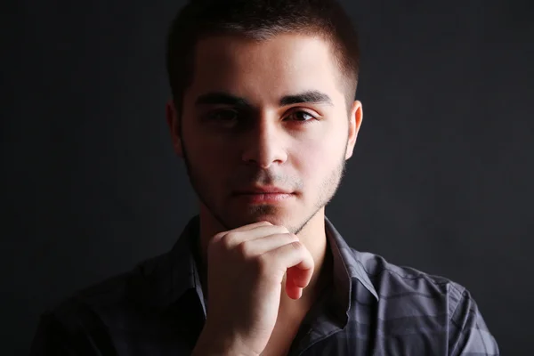 Handsome young man on dark background — Stock Photo, Image