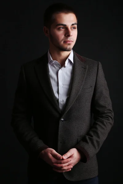 Handsome young man on dark background — Stock Photo, Image