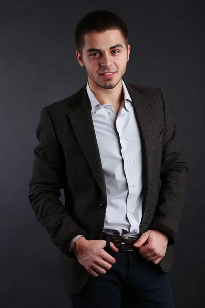 Handsome young man on dark background — Stock Photo, Image