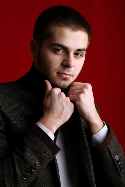 Handsome young on red background — Stock Photo, Image