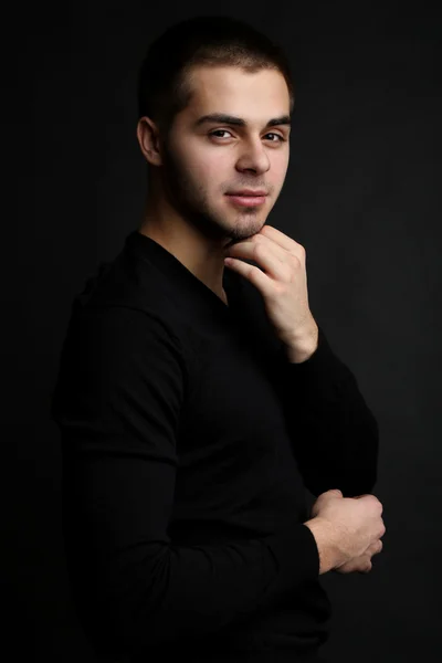 Handsome young man on dark background — Stock Photo, Image