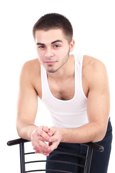 Handsome young man with chair isolated on white — Stock Photo, Image