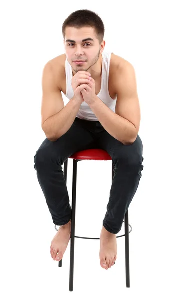 英俊的年轻男子坐在椅子上上白色孤立 — 图库照片