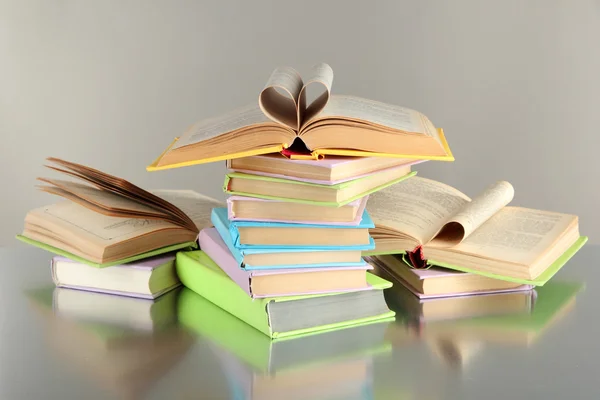 Stacks of books on grey background — Stock Photo, Image