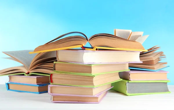 Stacks of books on table on natural background — Stock Photo, Image