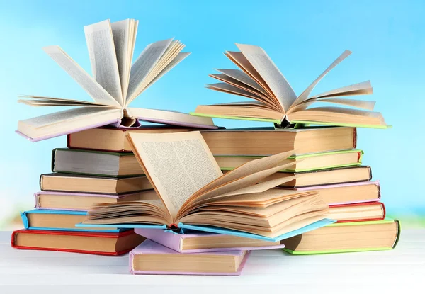 Stacks of books on table on natural background — Stock Photo, Image