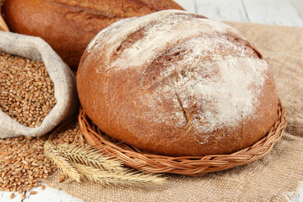 Rye bread with grains on sackcloth on table close up