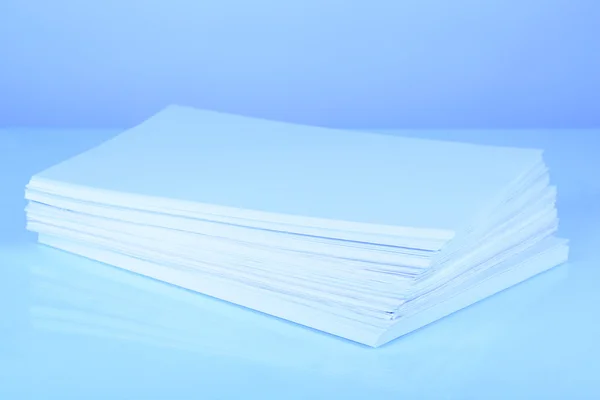 Stack white paper in blue light — Stock Photo, Image