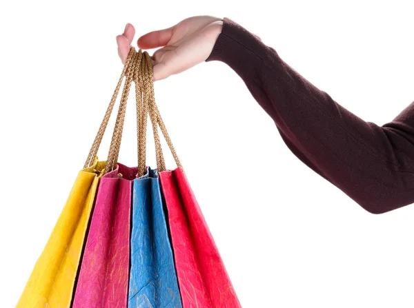 Renkli alışveriş torbaları üzerinde beyaz izole kadın elinde — Stok fotoğraf