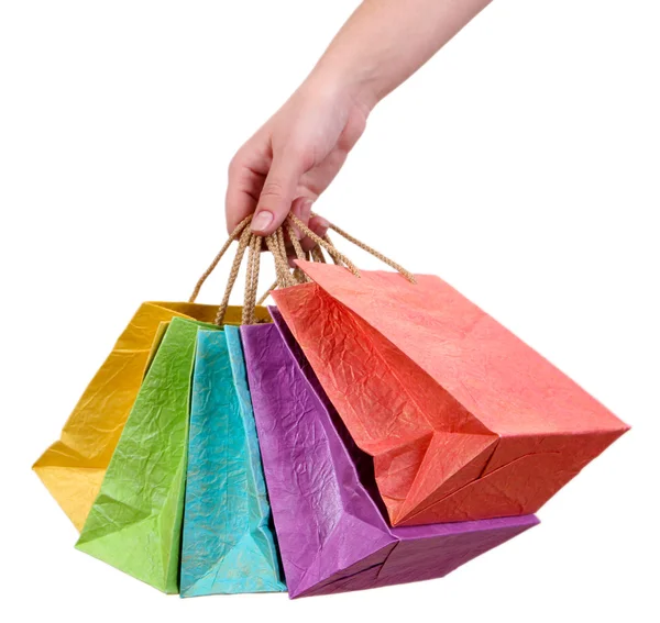 Bolsas de compras coloridas en mano femenina, aisladas en blanco — Foto de Stock