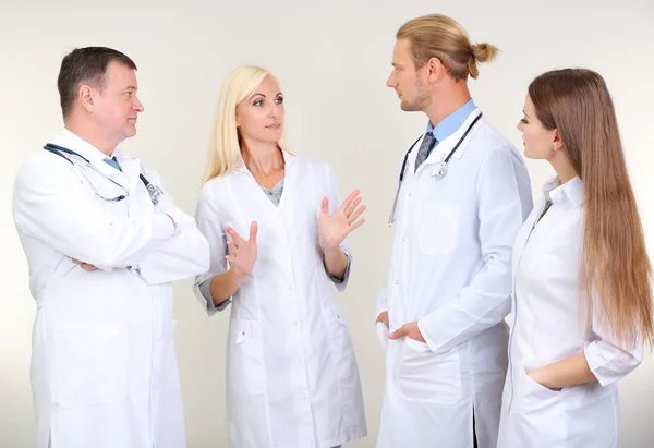 Medical workers on grey background — Stock Photo, Image