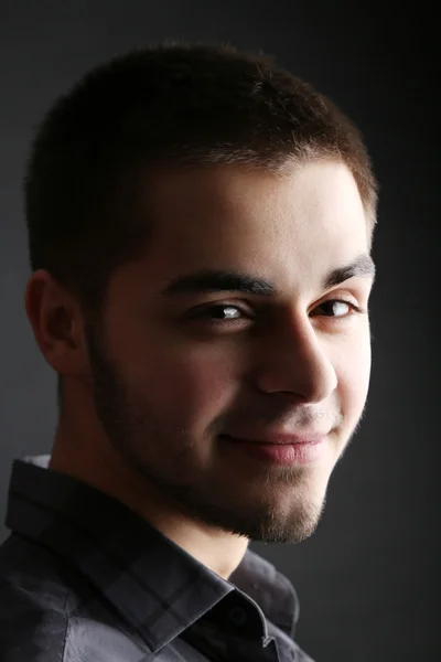 Handsome young man on dark background — Stock Photo, Image