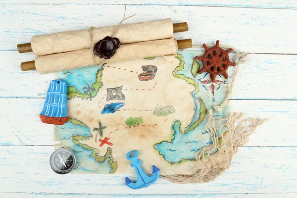 Treasure map with sea accessories, on wooden background — Stock Photo, Image