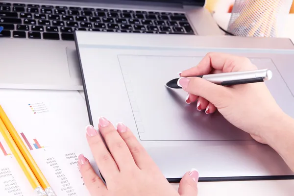 Main féminine à l'aide d'une tablette graphique sur la table gros plan — Photo