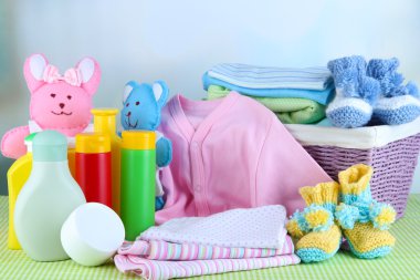 bebek sepeti masaya renk arka plan üzerinde elbise yığını