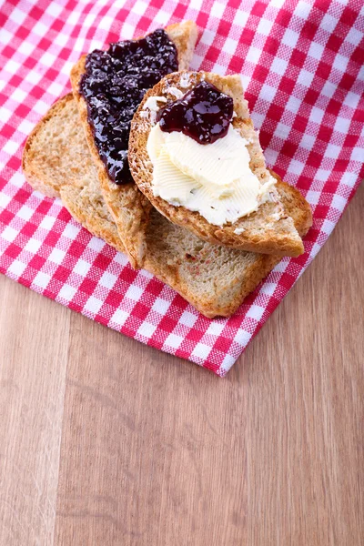 Delicious toast with jam on table close-up — Stock Photo, Image