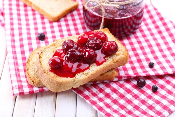 Delicious toast with jam on table close-up — Stock Photo, Image