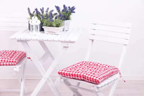 Garden chairs and table with flowers on white background — Stock Photo, Image