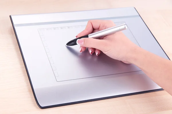 Female hand using graphics tablet on table close up — Stock Photo, Image