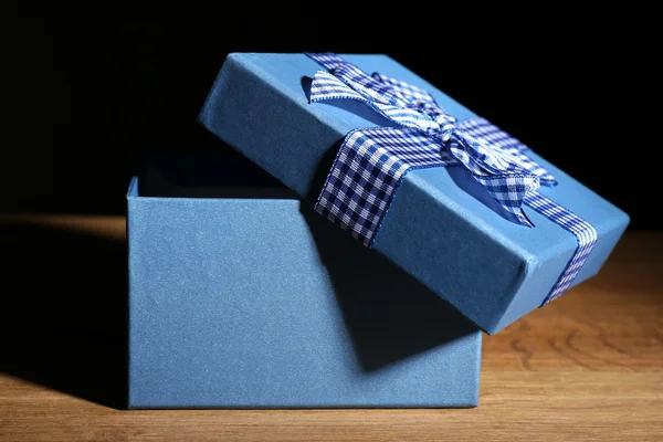 Open gift box on dark background — Stock Photo, Image