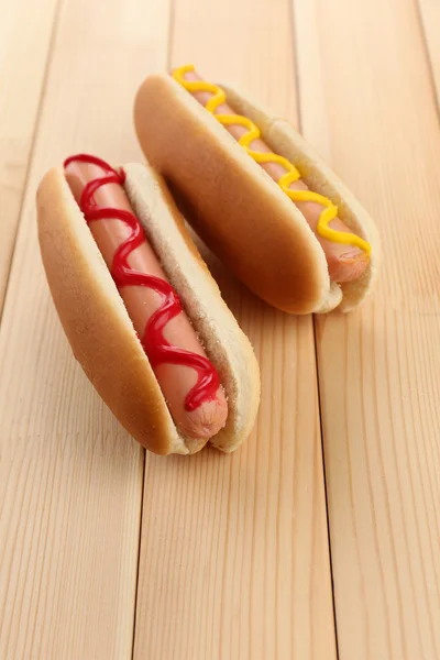 Tasty hot dogs on wooden table — Stock Photo, Image