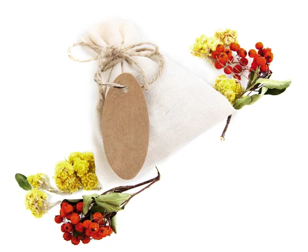 Textile sachet pouch with dried flowers, herbs  and berries, isolated on white — Stock Photo, Image