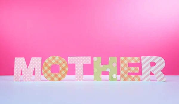 Mother- lettering of handmade paper letters on pink background — Stock Photo, Image