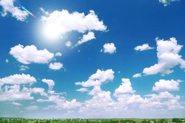 Blue sky with clouds and sun — Stock Photo, Image