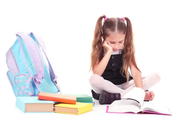 Menina bonita, livros e uma mochila isolada em branco — Fotografia de Stock