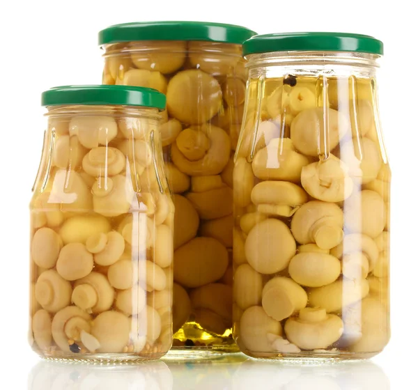 Three glass jars of marinated mushrooms isolated on white — Stock Photo, Image