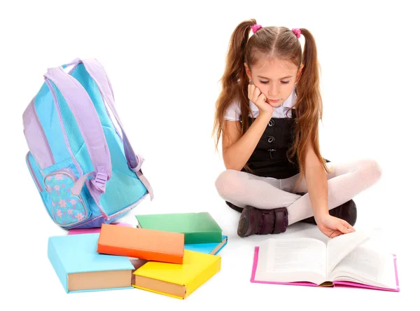 Beautiful little girl, books and a backpack isolated on white Stock Photo