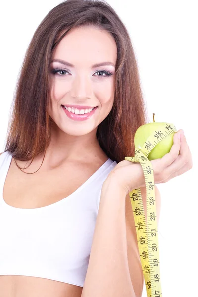 Mooie jonge vrouw met groene apple en meetlint geïsoleerd op wit — Stockfoto