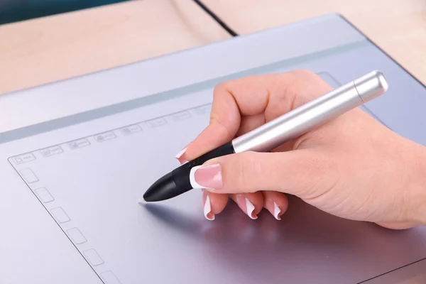 Female hand using graphics tablet on table close up — Stock Photo, Image