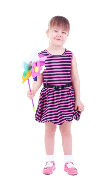 Güzel küçük bir kız üzerinde beyaz izole renkli rüzgar türbini holding — Stok fotoğraf